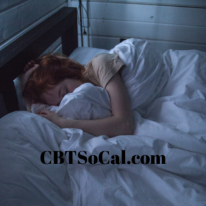 A woman who struggles with insomnia sleeps peacefully in her bed after using cognitive behavioral therapy for insomnia
