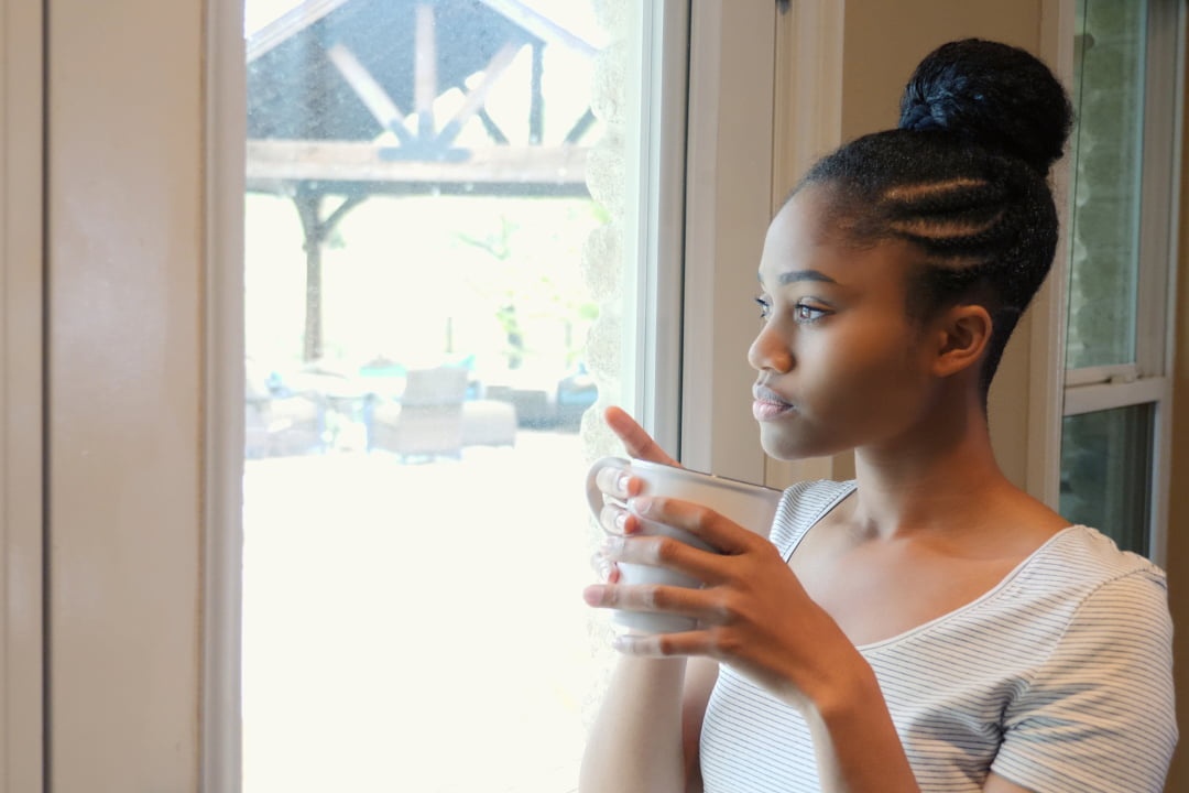 girl looking out of her window